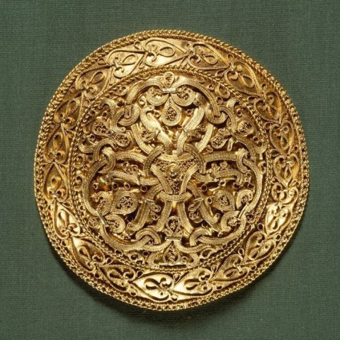 A circular golden Viking brooch from Hornelunde near Varde in Denmark. This brooch, decorated with wire filigree and granulation, was made by a Danish goldsmith in the last half of the tenth century.