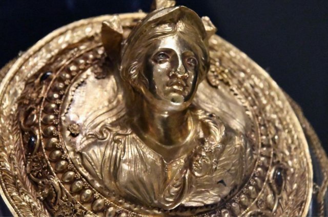 Gold medallion with a bust of Athena with blue enamel inlay eyes, 2nd century BC, Greece.