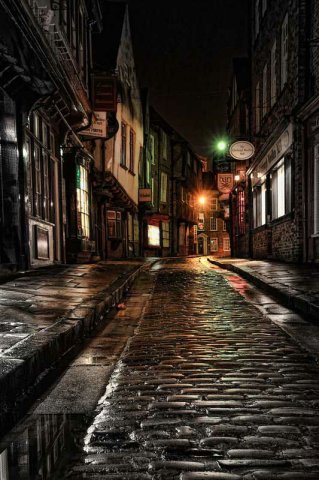 Wet night on the cobblestone street in the Shambles, Yorkshire, England.